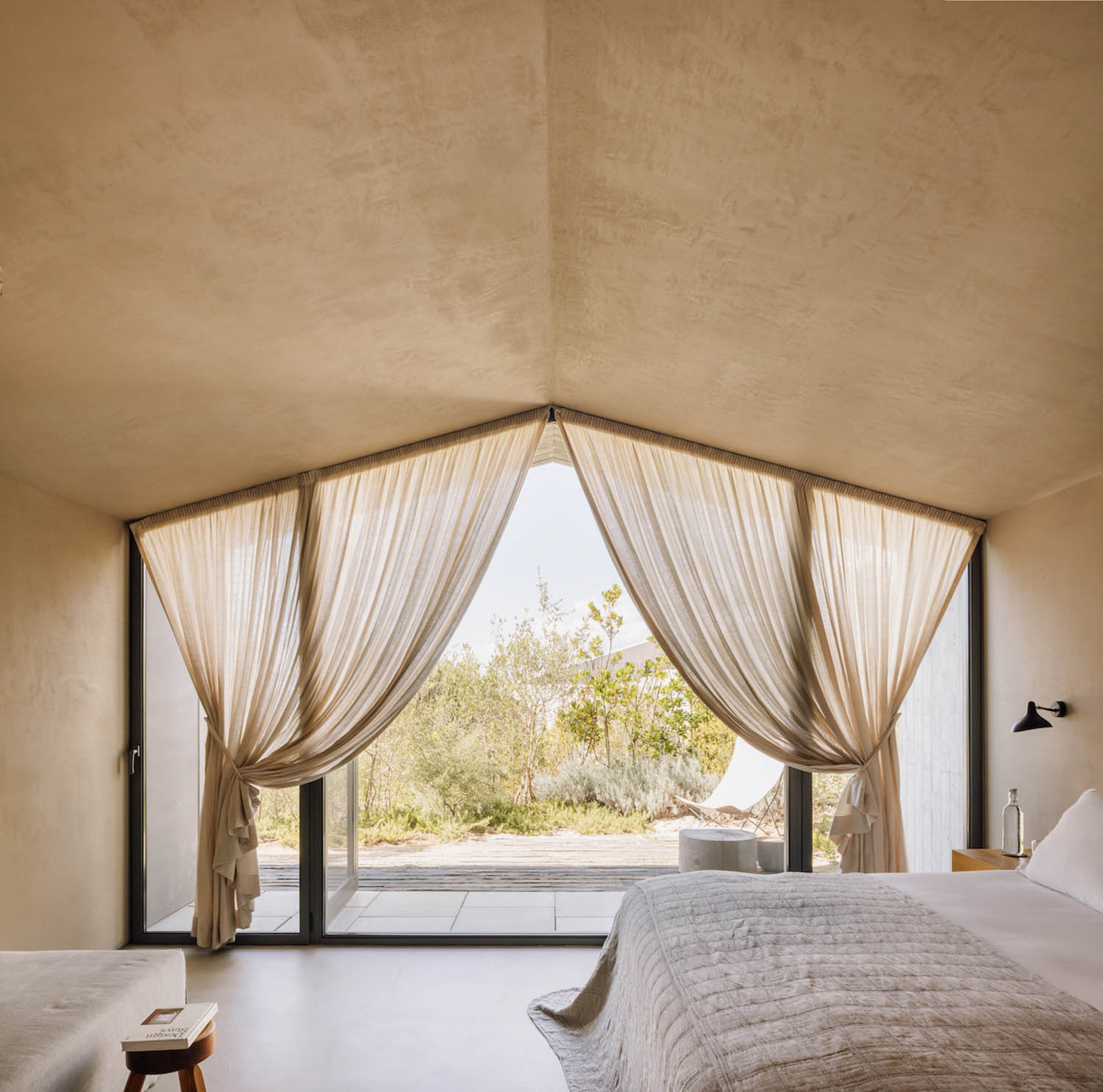 bedroom with gauzy white curtains