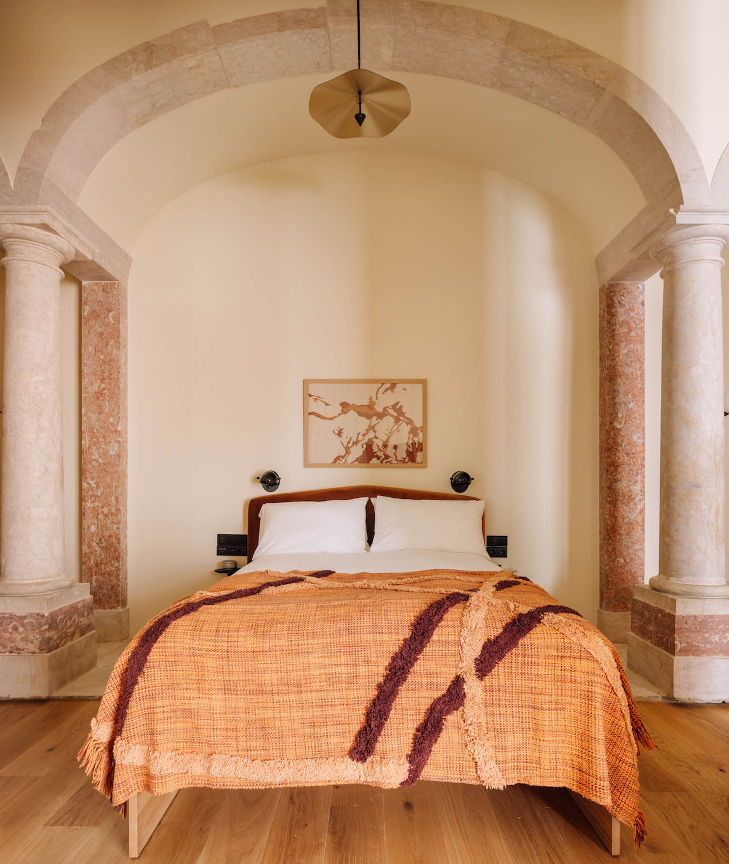 bedroom with peach sheets and white walls