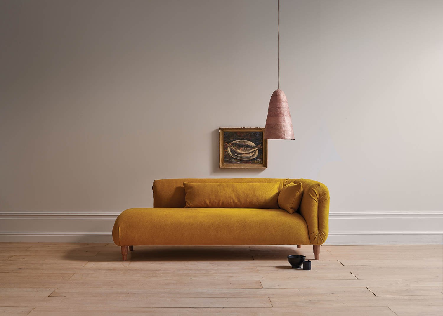 yellow sofa underneath hanging light