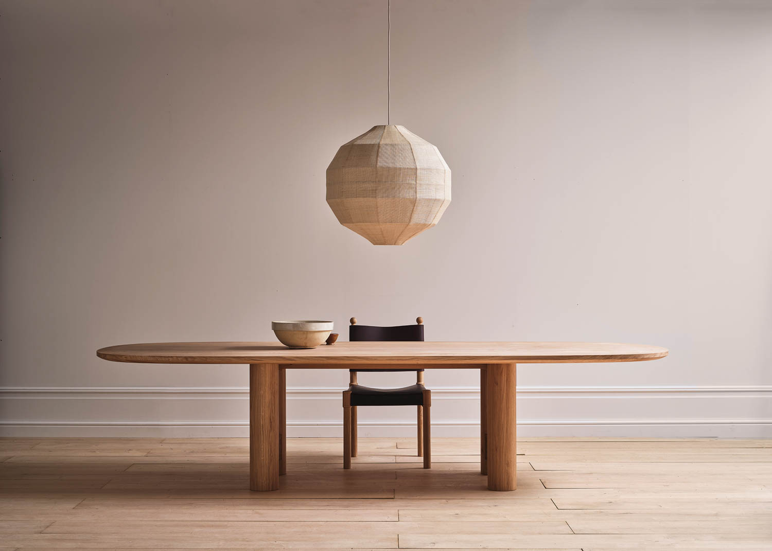 long wooden desk underneath a paper lantern