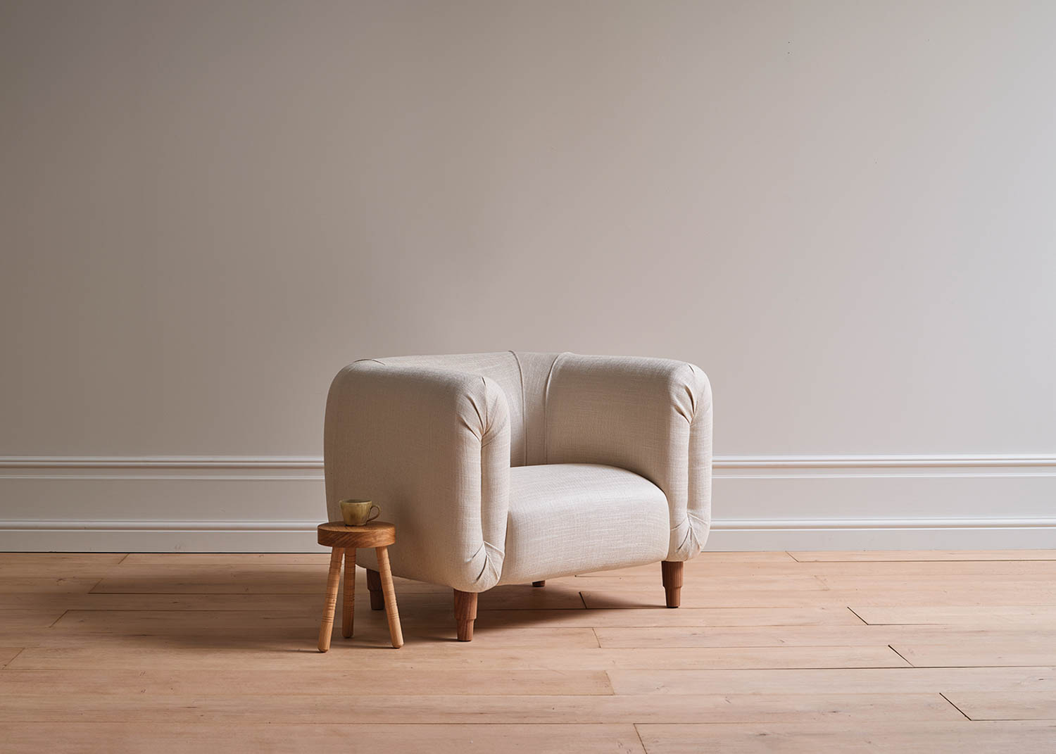 white armchair and wooden stool