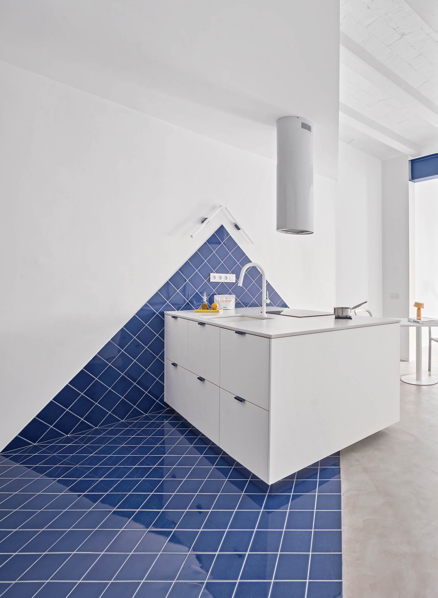 white cabinet against blue tile