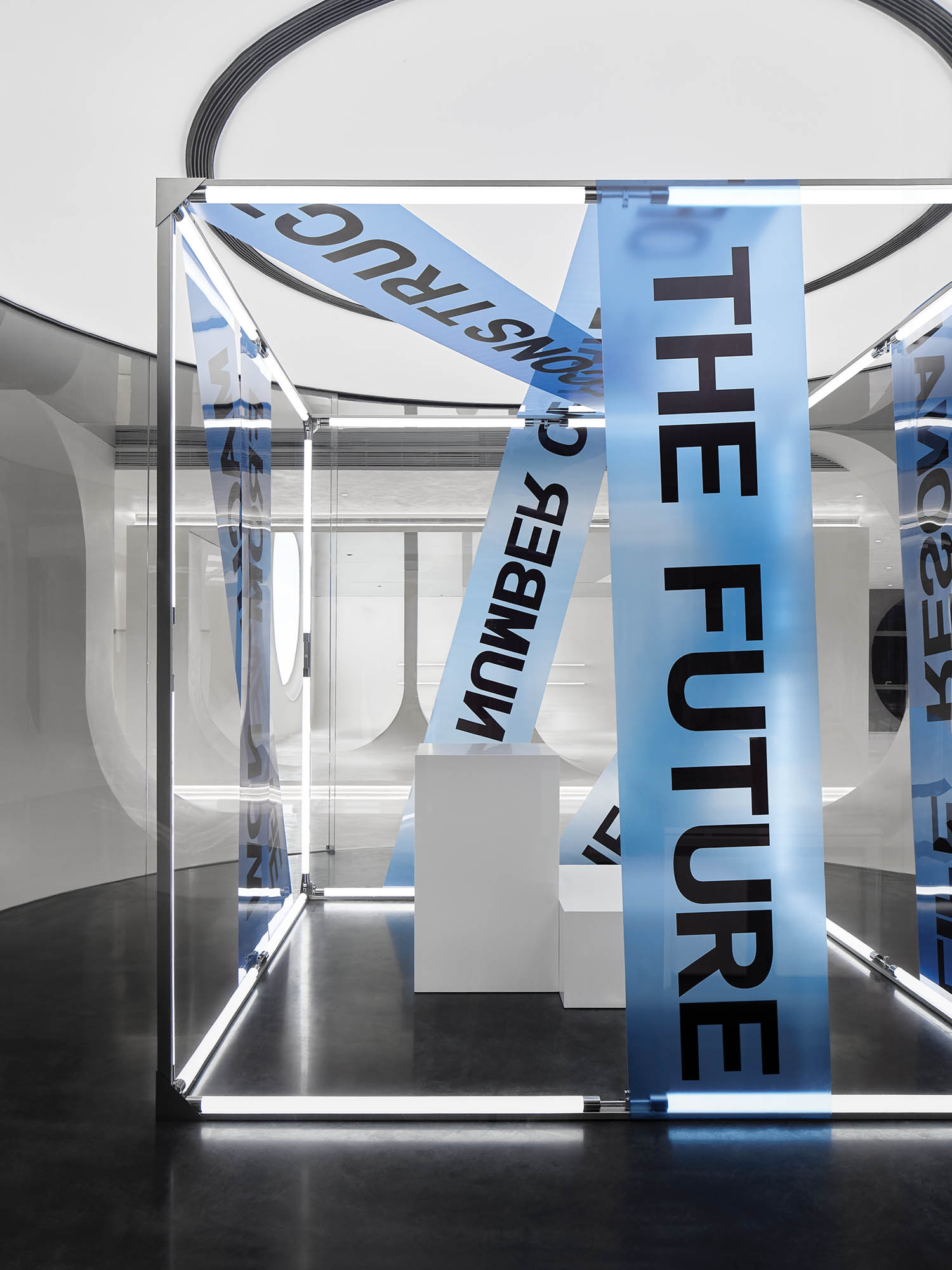 glass-enclosed gallery with strips with printed phrases