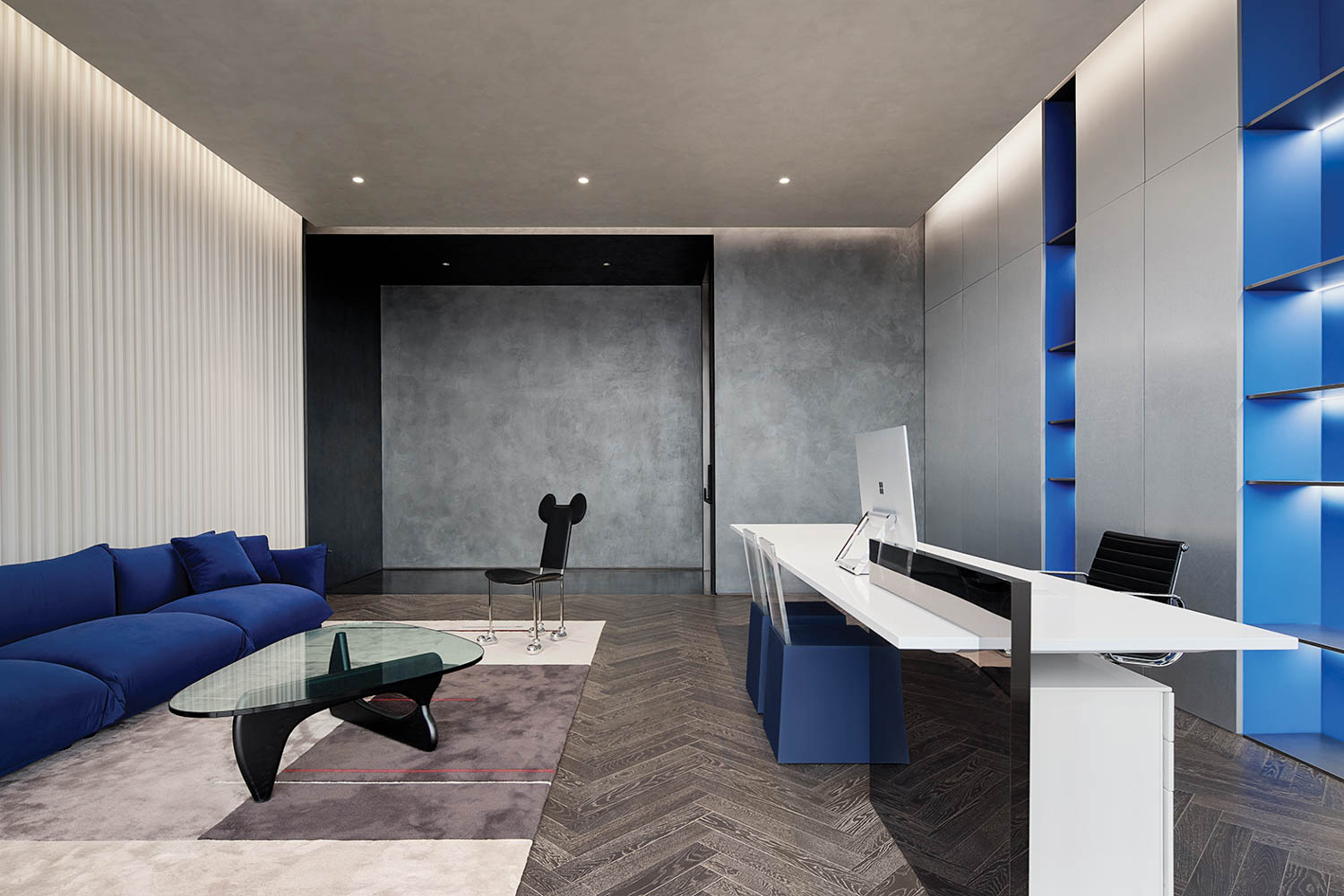 office space with blue chairs, embossed wallcovering and wood flooring