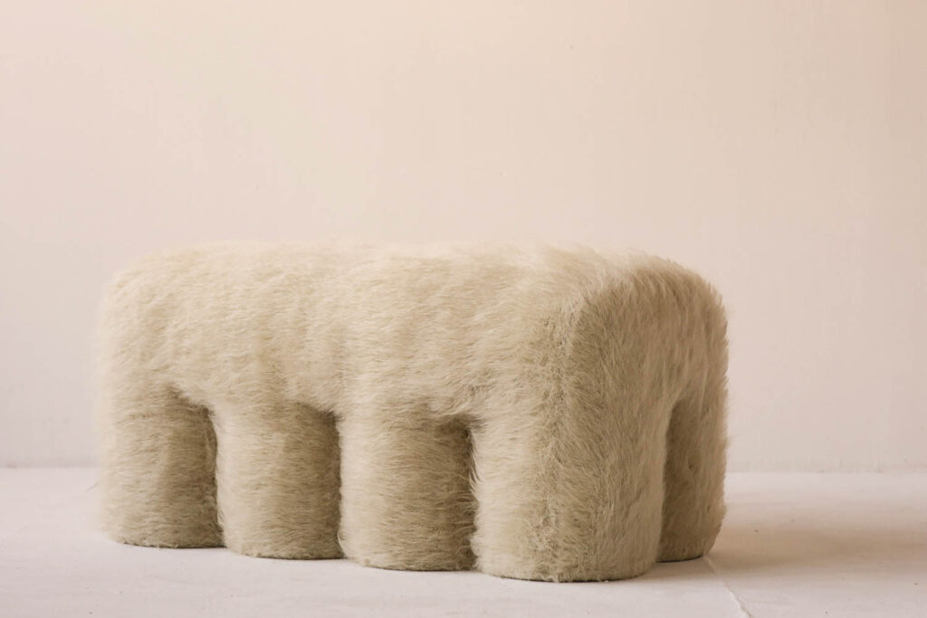 a fuzzy bench with four legs