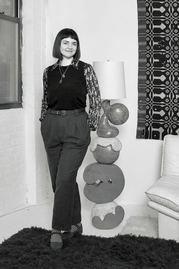 designer standing next to her floor lamp