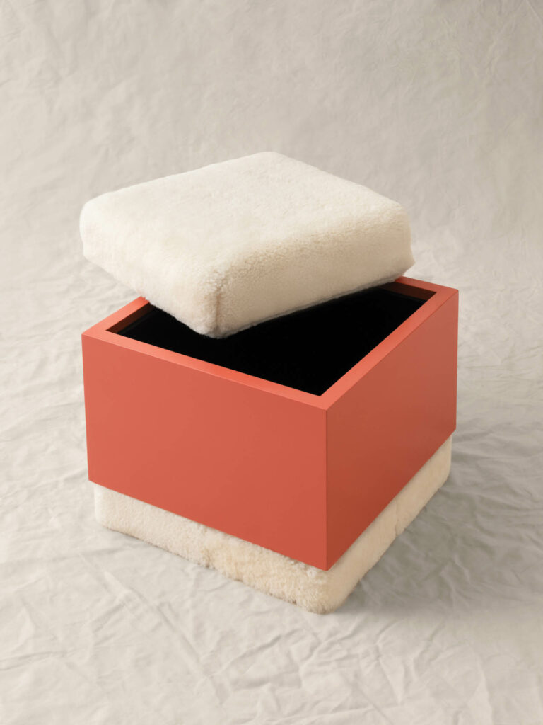 ottoman with a white removable top and orange base