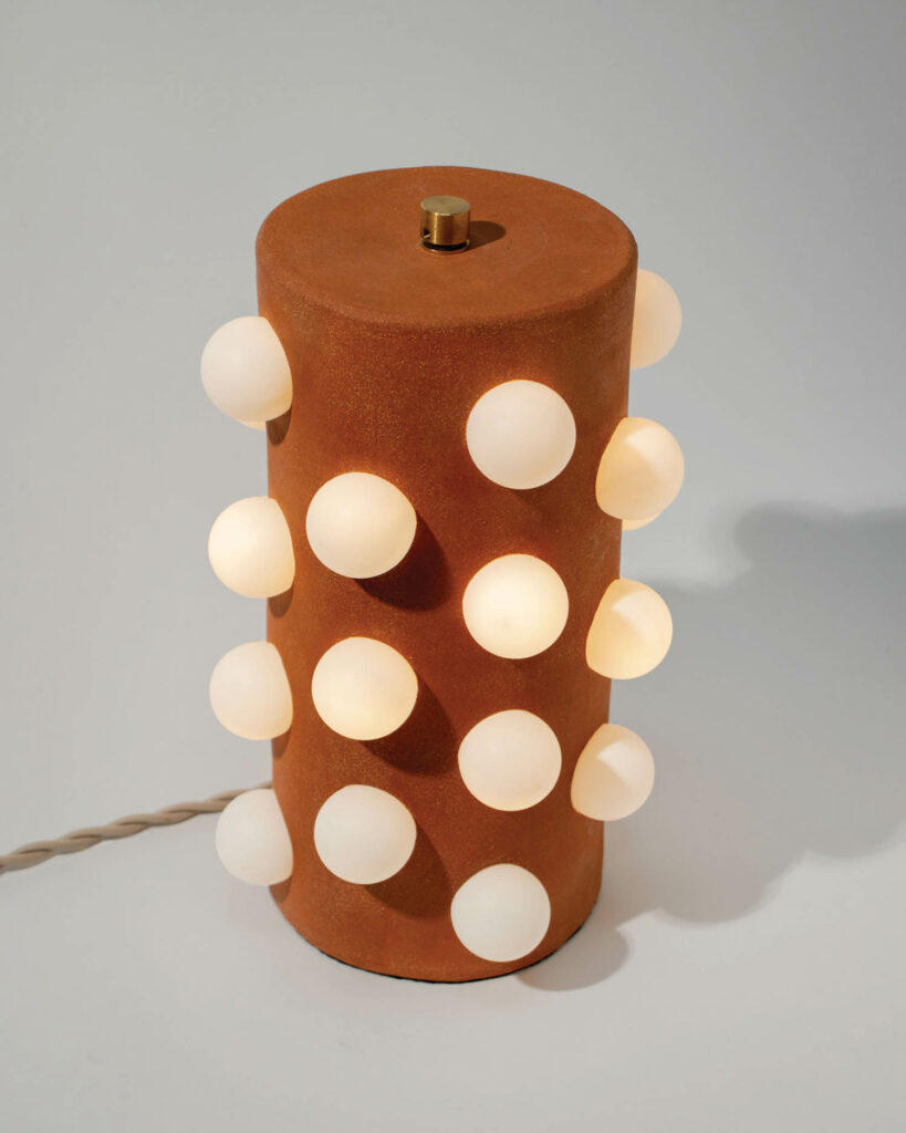 a lamp with white bulbs around it