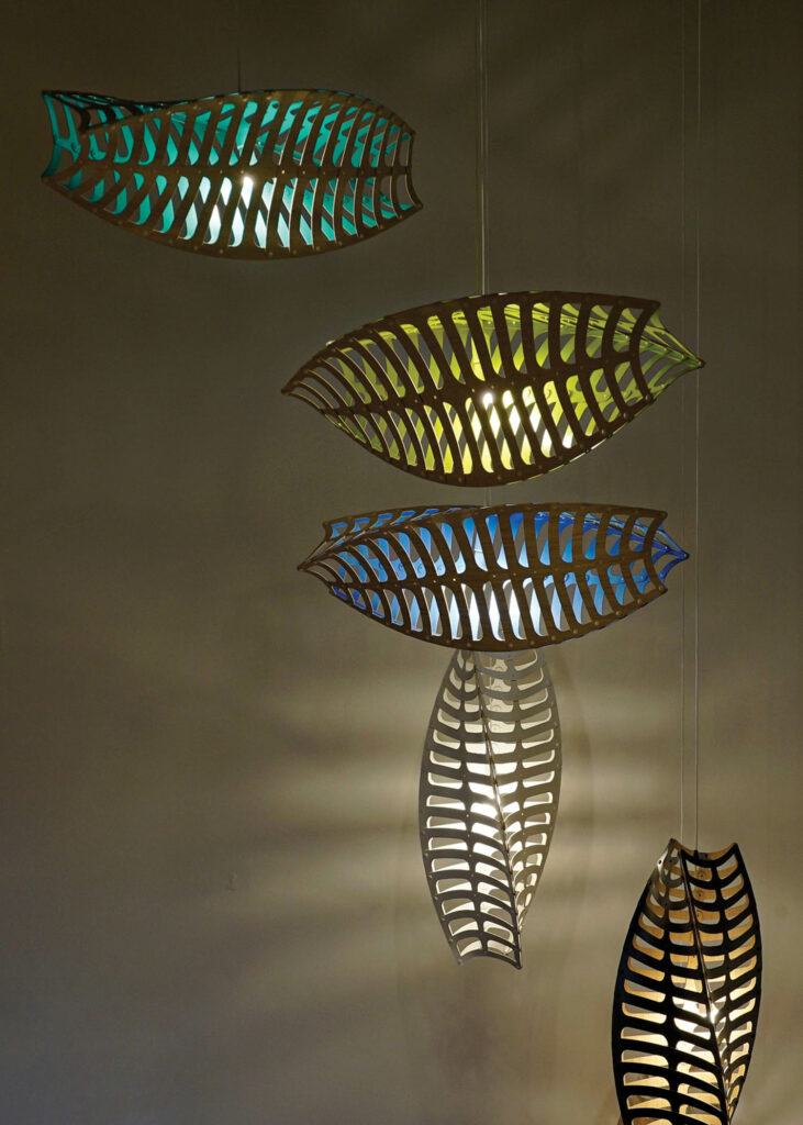 Toru bamboo-plywood pendants with colored interiors by David Trubridge