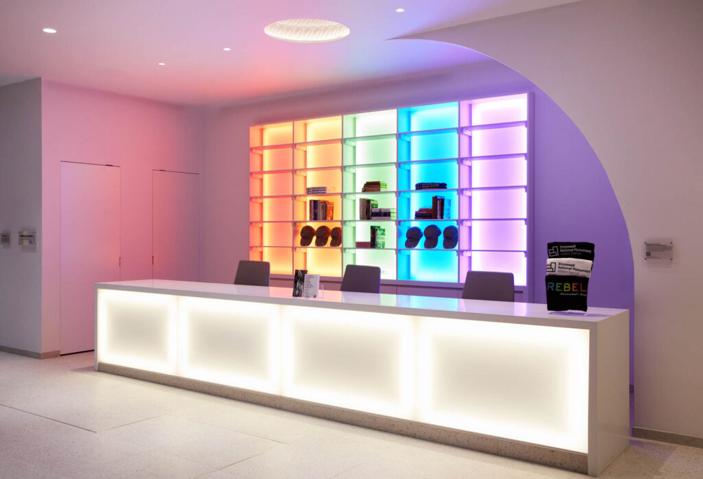 colorful reception area with multicolored backlights and brightly lit reception desk