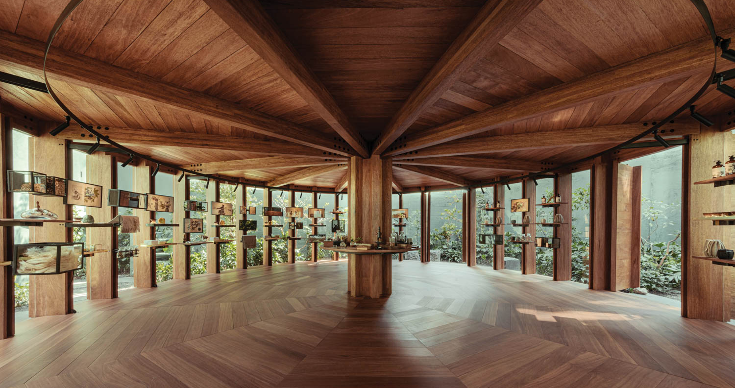 open pavilion with wooden ceilings and floors with screens and shelves all around